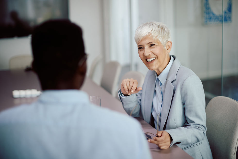 Two senior leaders engaged in a strategic one-on-one discussion in a professional office setting.