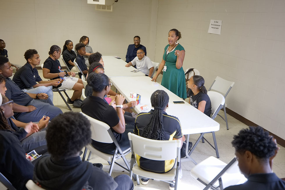 Young attendees seated around tables during a health discussion at the September 2026 summit