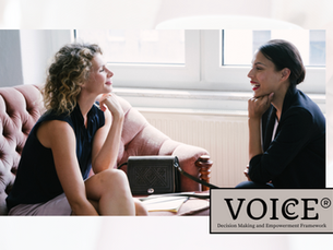 2 Women having a conversation smiling.