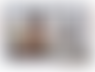 A woman sitting at the desk smiling.