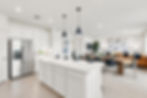 Open-concept kitchen and dining area with a large white island