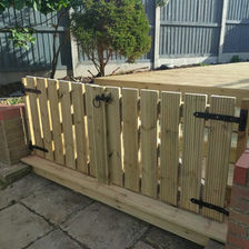 wooden picket gate enclosing decking area