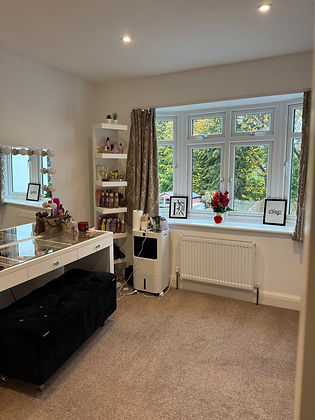 Cozy living room with window, shelves, table, and visible decorations. House Cleaning.
