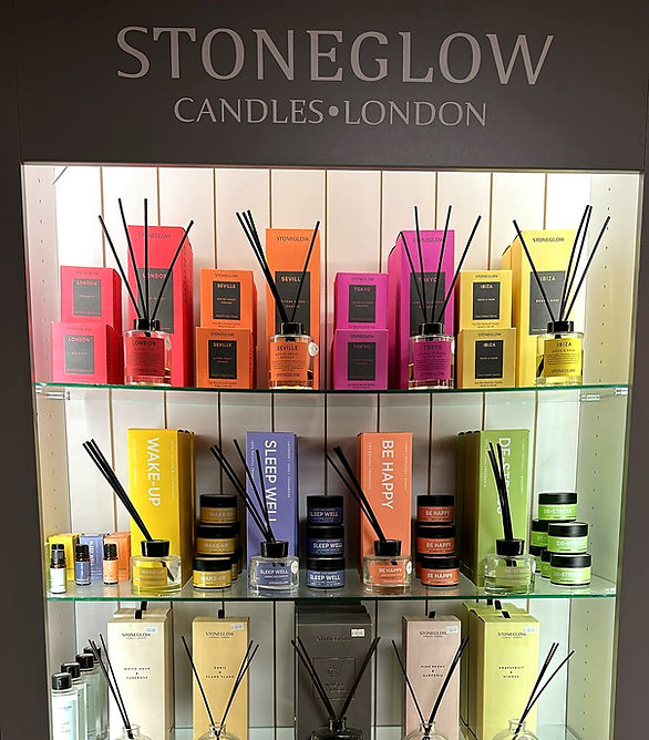 STONEGLOW CANDLES LONDON, colorful diffusers on display, HOME ACCESSORIES, retail store setting.