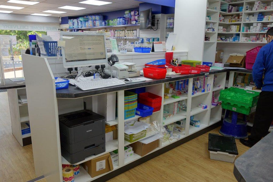 behind the desk at a pharmacy reception