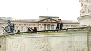Victor Hampson as Thomas Wrinklesmooth outside Buckingham Palace in London
