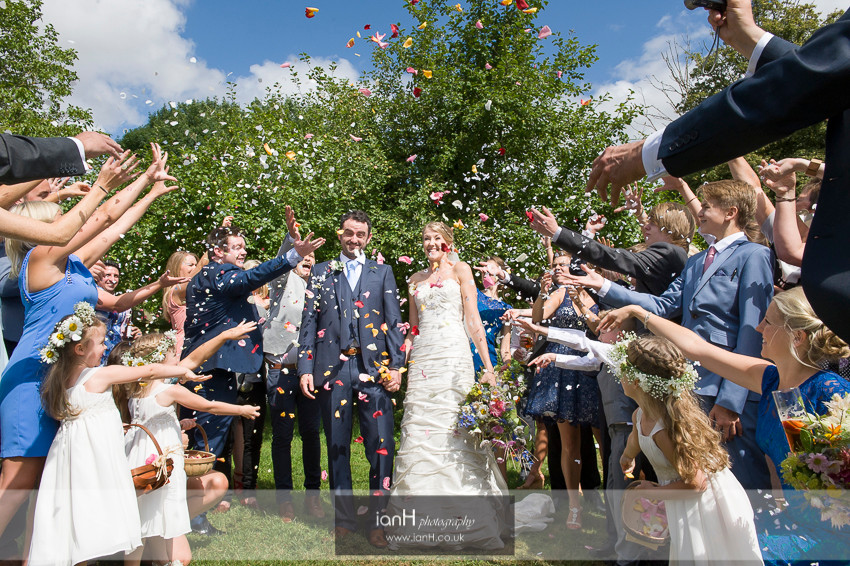 A shower of confetti falls on the Bride and Groom