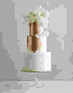 3 Tier White Wedding Cake with a Splash of Gold and white flowers