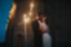 Wedding Photography: Groom and bride kissing at night ceremony under fairy lights