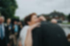 Wedding Photography: Woman embracing groom in a big hug and smile