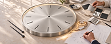Oversized stainless clock with warm LED lighting.png