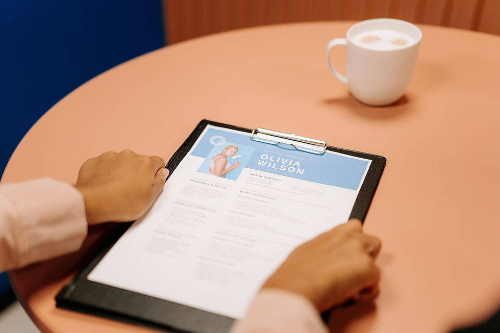 A person looking over their printed resume before submitting it to the employer