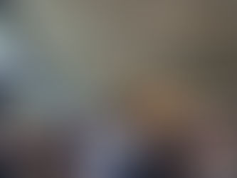 Wedding couple being lifted on chairs during celebration