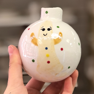 Bauble with a baby footprint on that has been painted to look like a Gingerbread man.