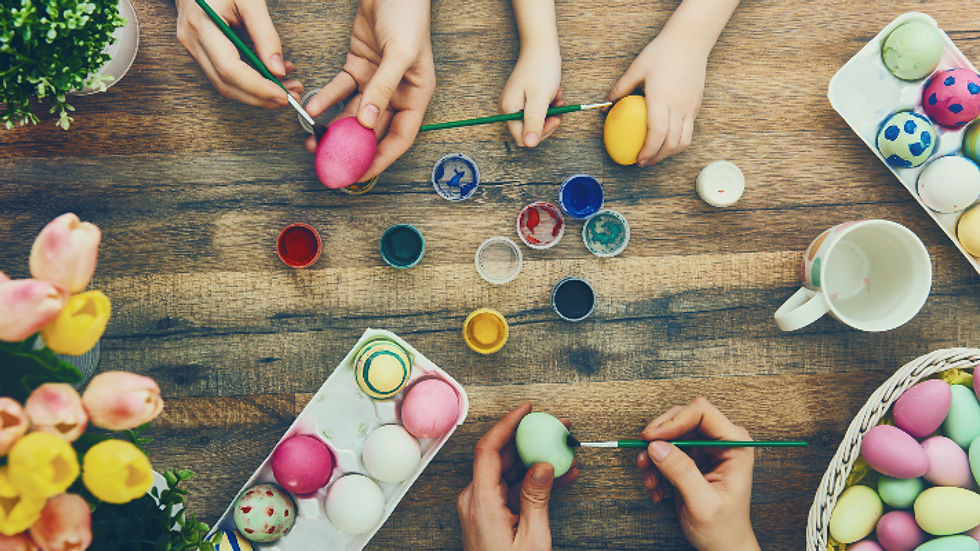 Close up of people of all ages painting designs onto eggs