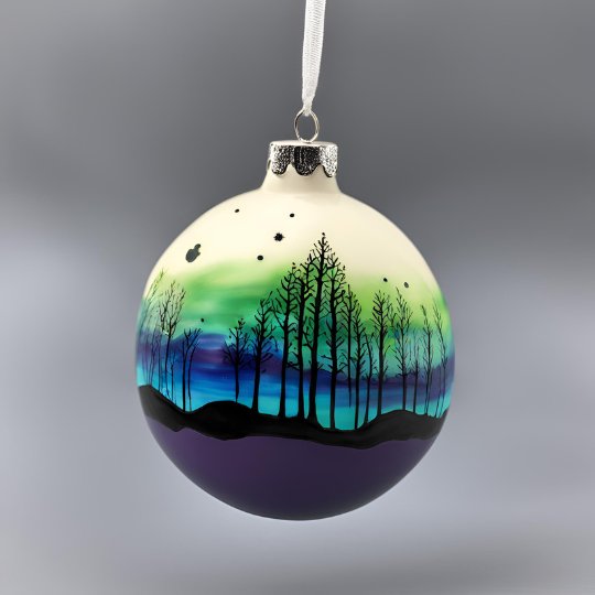 Bauble with an Aurora skyline and tree silhouettes painted on.