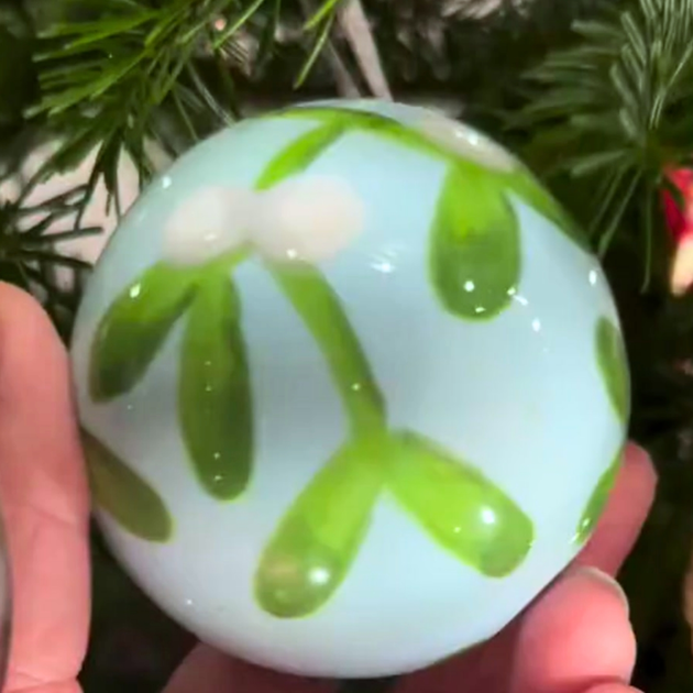 Misletoe design painted onto a ceramic bauble