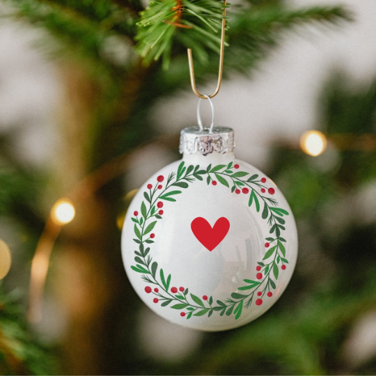 Christmas bauble with a wreath design that has a heart in the middle.