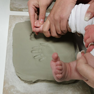 A baby getting imprints done at Crafty Monkey