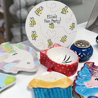 Ceramic pieces painted at a hen party at Crafty Monkey Pottery Painting Studio, includes plates, bowls and a keepsake piece for the bride to be