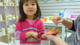 Pottery painting session for babies and toddlers featuring hand and foot prints
