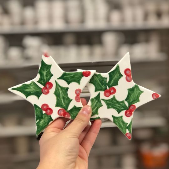 Ivy with berries painted on star hanging ornaments.