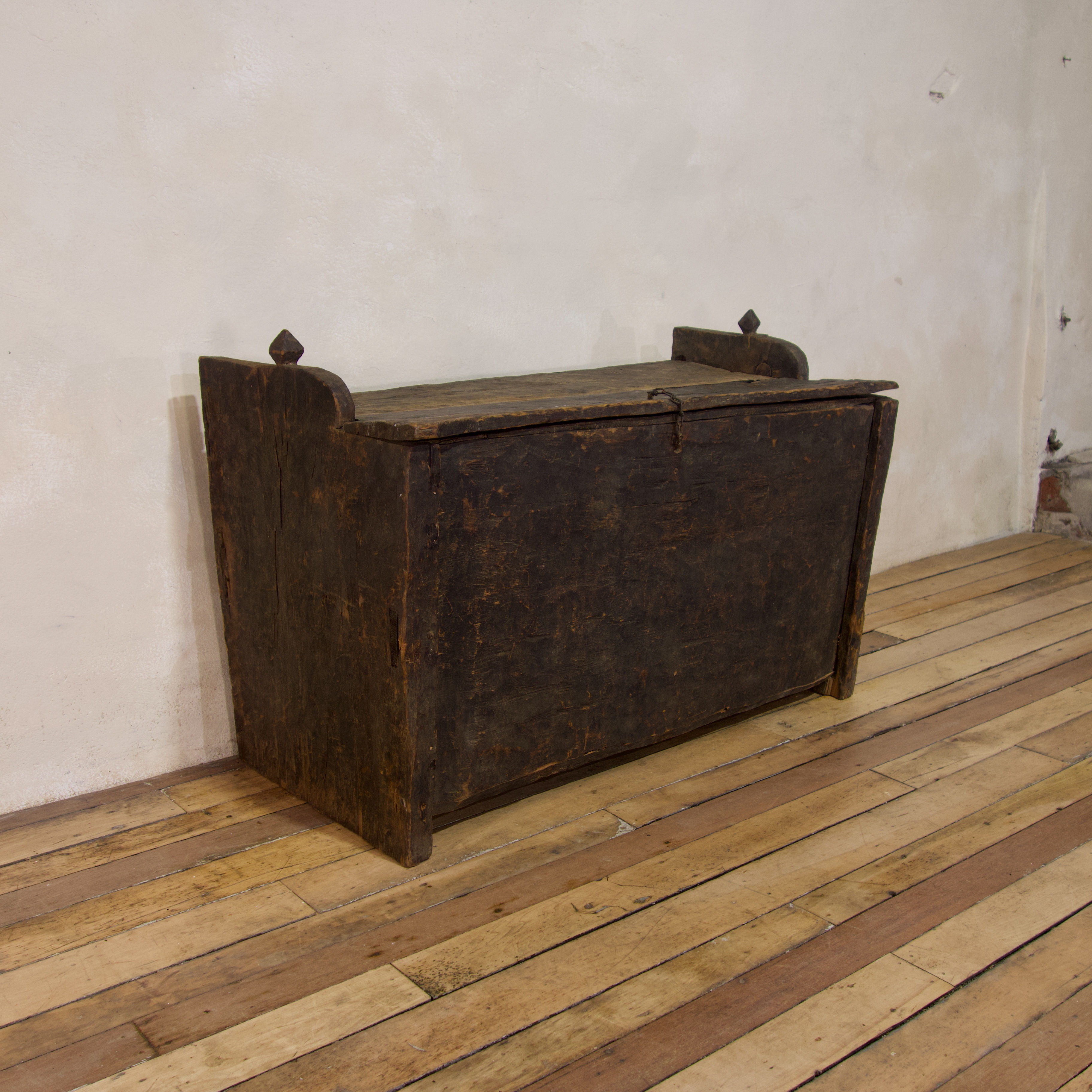 A late 18th Century Primitive Cedar Black Painted Settle - Trunk