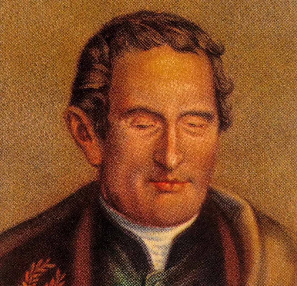 Retrato pintado de Louis Braille, inventor francês do sistema de leitura e escrita para pessoas cegas. Ele aparece com cabelo curto e escuro, olhos fechados, vestindo casaco escuro de gola alta e camisa branca. No ombro esquerdo há um detalhe decorativo semelhante a uma coroa de louros. O fundo em tons quentes destaca suas feições e transmite solenidade, reforçando sua importância histórica como criador do método Braille.