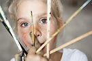 headshot-adorable-female-blonde-child-holding-brushes-her-hand-looking-smiling-cute-little