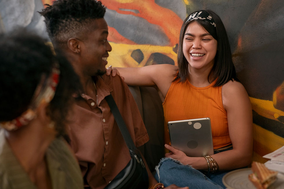 Diverse group of friends socializing in a welcoming setting, reflecting community support and connection in healing and recovery