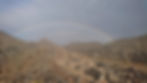 A Rainbow over the Hajar Mountain Range in Oman, Representing the Hope that Financial Independence Offers