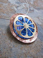 Seed Pod Inspired pendant in copper, brass, aluminium and silver by Eleanor J Watson Narrative Jeweller