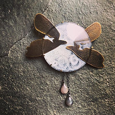 Myths of Moths and the Moon - a narrative brooch made by Eleanor J Watson - includes enamel, brass, sapphires, silver and a glass watch face
