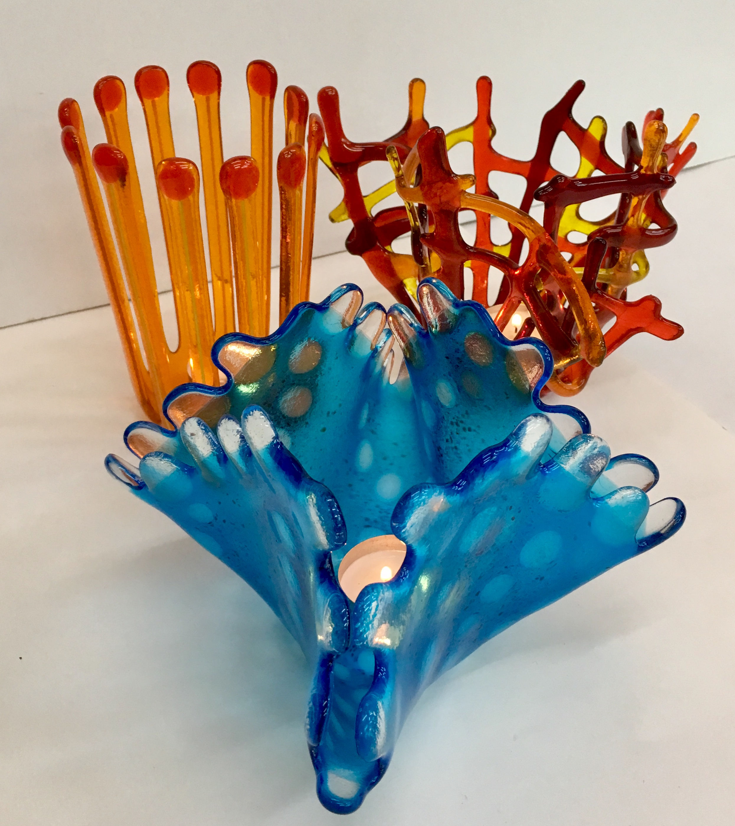 Three different floral slumped vessels made by Eleanor at Rainbow Glass Studios on the Intermediate Floral Drapes course