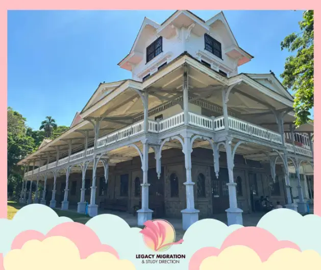 Historic white university building under a clear blue sky