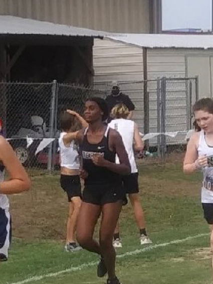 Natalie Black running a race on a grassy field