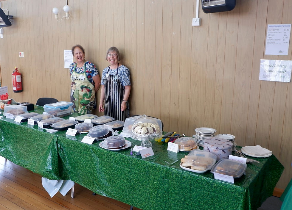 Happy volunteers ready to serve visitors delicious homemade cakes