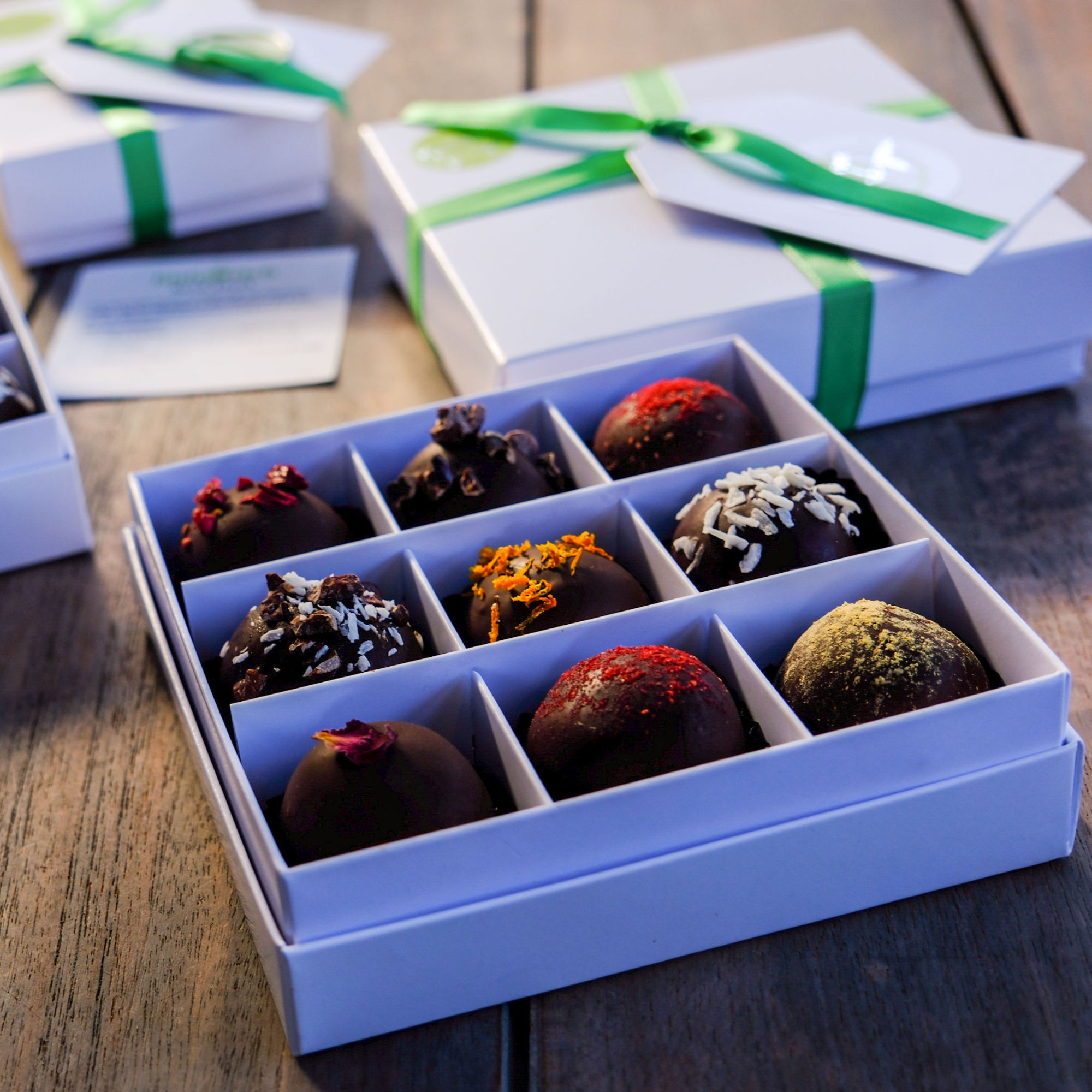 Chocolate Bliss Ball Classic Gift Box of nine bliss balls shown with gift ribbon and tag.