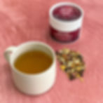 Front view of Winters Deep herbal tea tub with mug of tea and loose blend