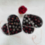 Decorative photo showing an example of a wedding package - two heart shaped large gift boxes filled with various chocolate bliss balls with decorative ribbons