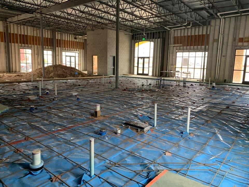 Pre-construction termite soil treatment at a Midland-Odessa building pad with plumbing and vapor barrier -- Tejas Pest and Weed Control