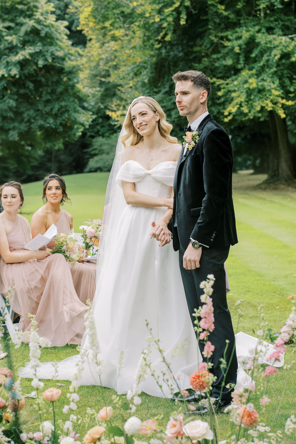 the bride and groom are holding hands during their wedding ceremony