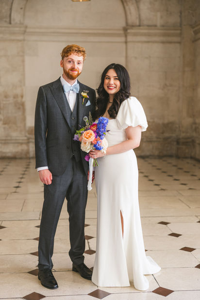 Aoife wearing the Calla wedding dress by Edwina O’Gorman with her partner. Photography: Katie Kav Photography.