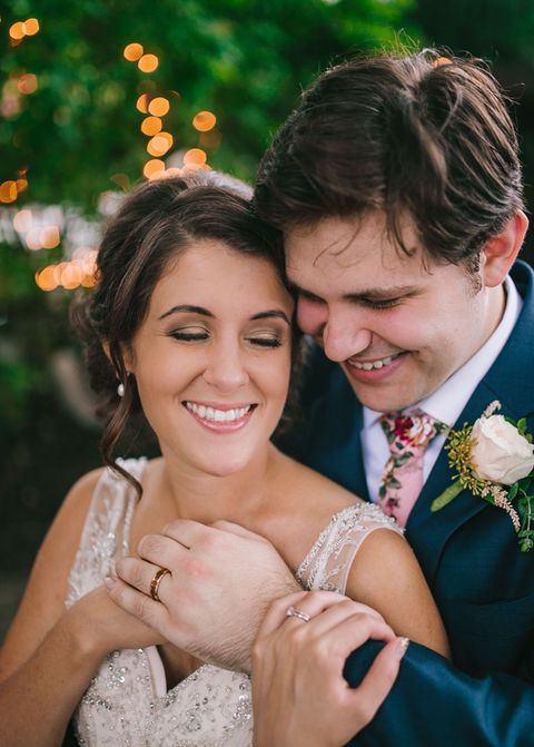 Happy bride and groom embracing outdoors