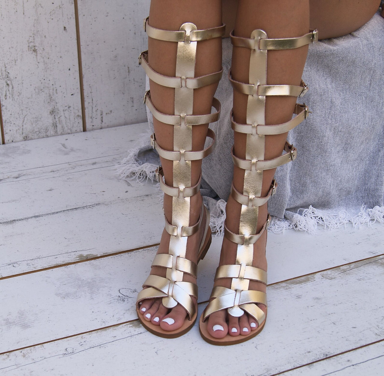 Gold full-grain leather gladiator sandals for women.