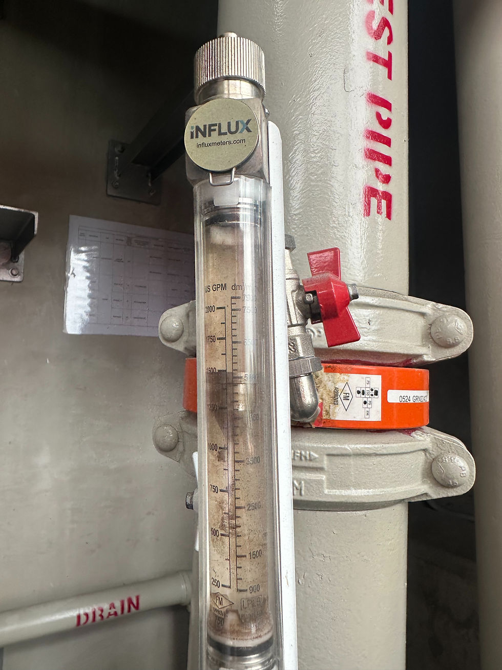 Water flow verification during a Fire Certificate Renewal inspection in Singapore.