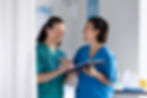 medium-shot-smiley-women-chatting-work.jpg