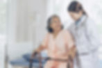 elderly-female-smiling-with-young-female-doctor-visiting-senior-patient-woman-hospital-war