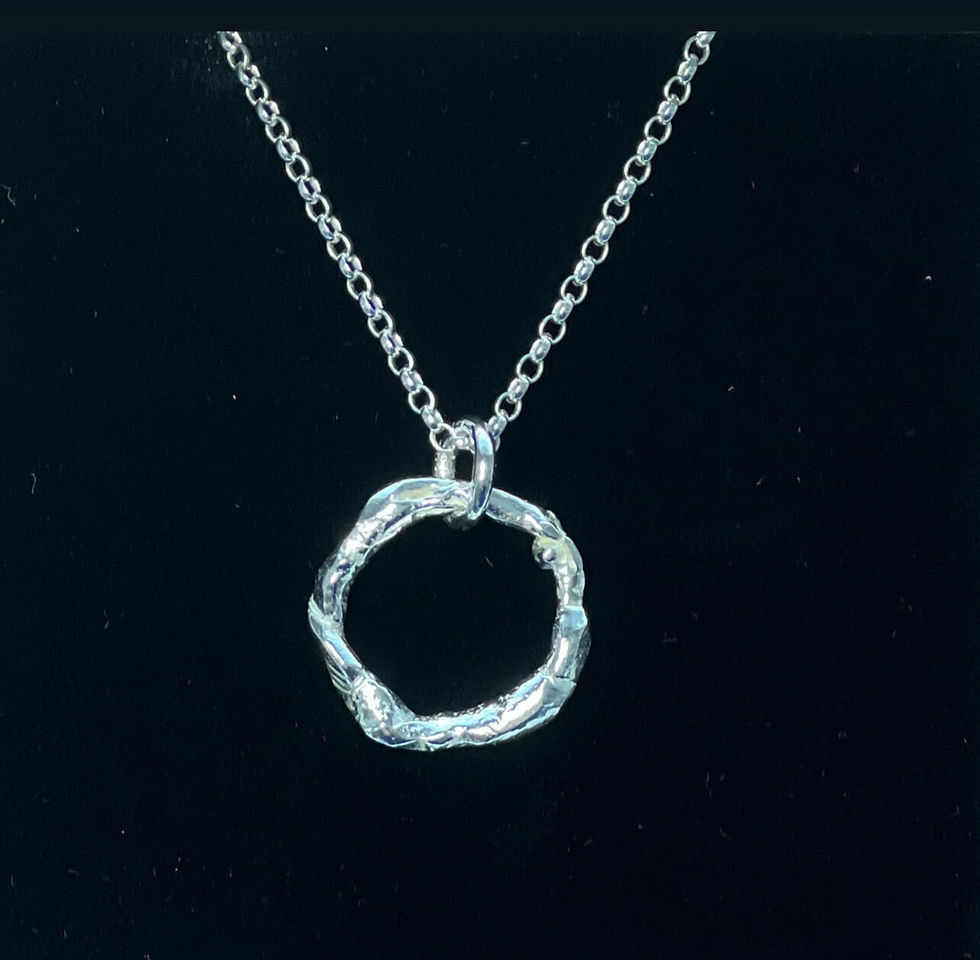 The molten CIrcle Pendant looks like liquid silver.