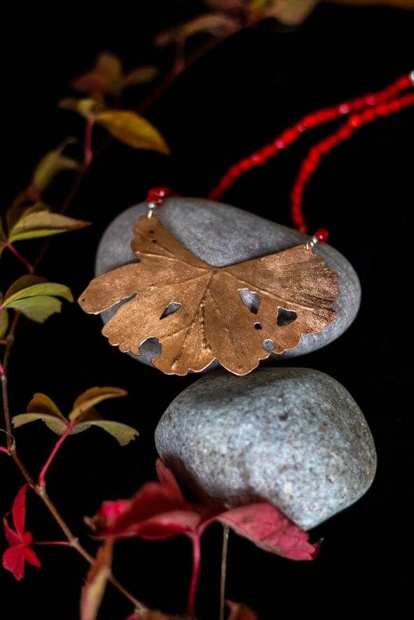 Unique pierced copper leaf and sea bamboo necklace by Claire Hart